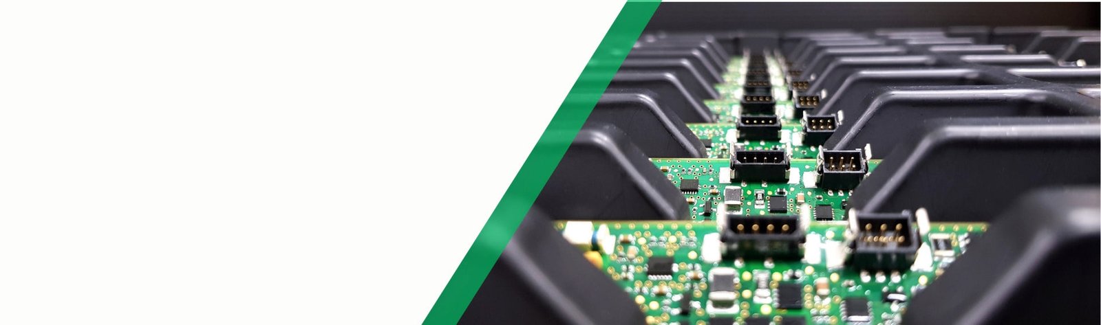 Assembled PCBs with connectors lined up in trays