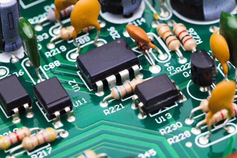 Through-hole and SMT components on a green PCB